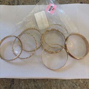 Guess Seven piece elegant gold colored Bangle Set